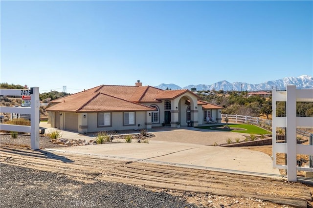 view of front of property featuring a mountain view and a garage