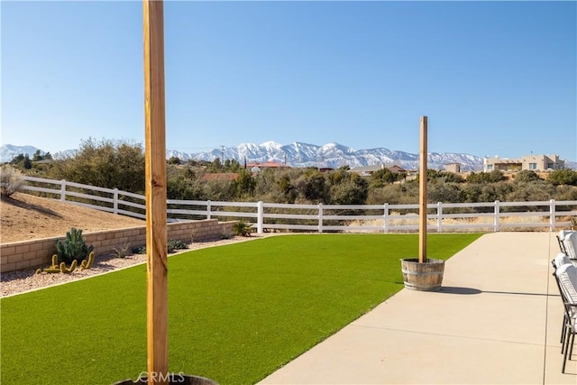 view of yard with a mountain view and a patio