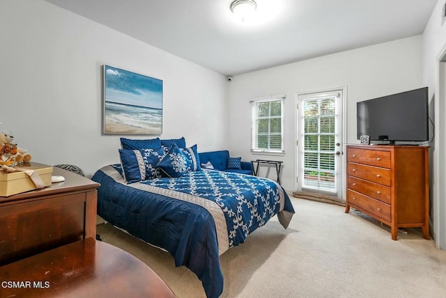 bedroom featuring access to outside and light colored carpet