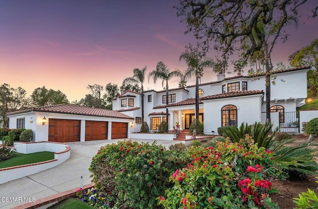 mediterranean / spanish-style house with a garage