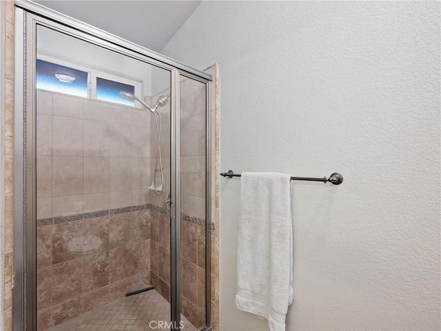 bathroom with a shower with shower door