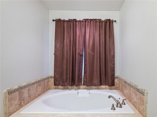 bathroom with a relaxing tiled tub