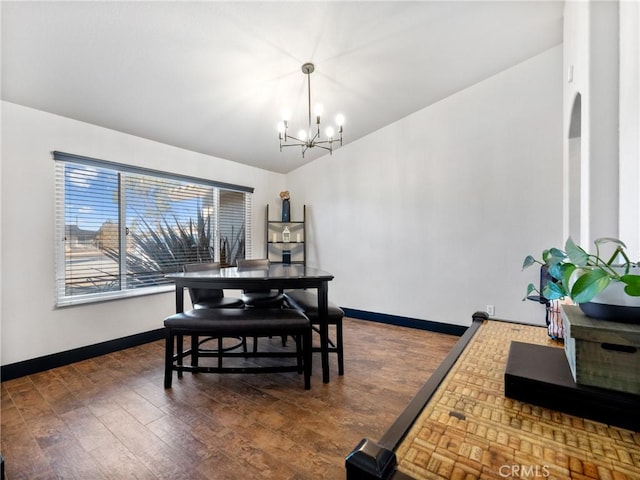 dining space with a notable chandelier and dark wood-type flooring