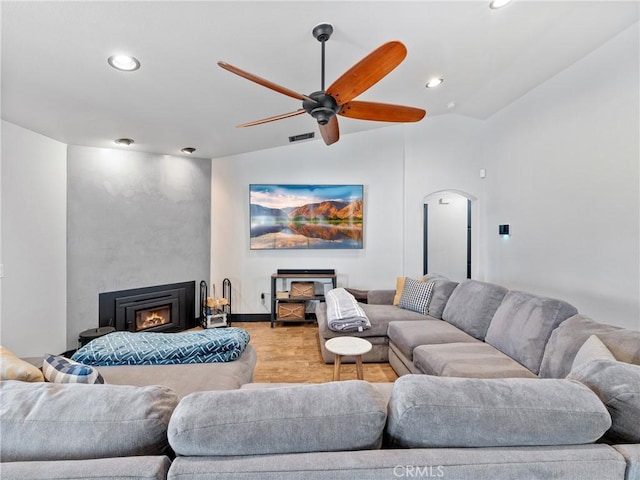 living room featuring vaulted ceiling, ceiling fan, and light hardwood / wood-style flooring