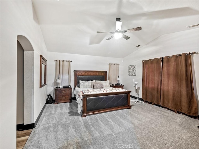 bedroom featuring ceiling fan, lofted ceiling, and light colored carpet