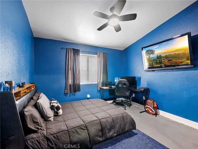 bedroom featuring ceiling fan, lofted ceiling, and concrete flooring