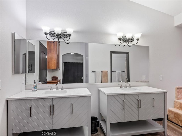 bathroom with vanity and a notable chandelier