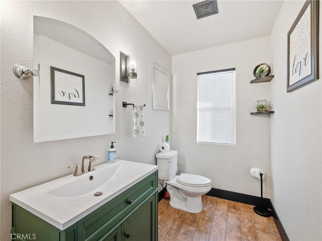 bathroom with vanity, hardwood / wood-style floors, and toilet