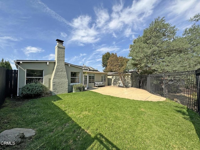 view of yard with outdoor lounge area and a patio