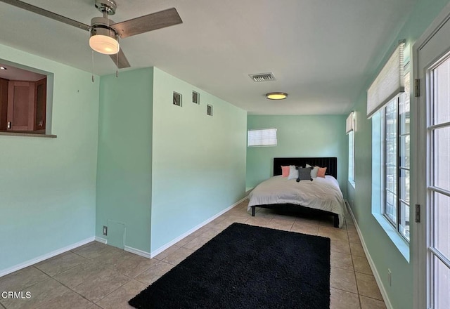 bedroom with ceiling fan and light tile patterned floors