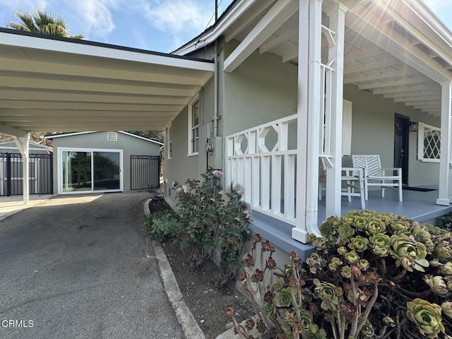 view of property exterior with a garage, an outbuilding, and a carport