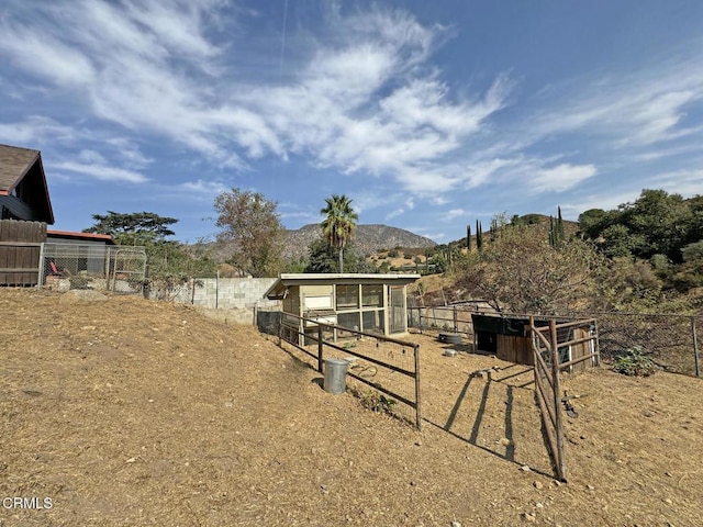 view of yard with a mountain view and an outdoor structure