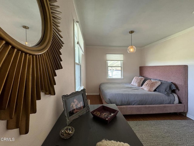 bedroom with ornamental molding and hardwood / wood-style floors