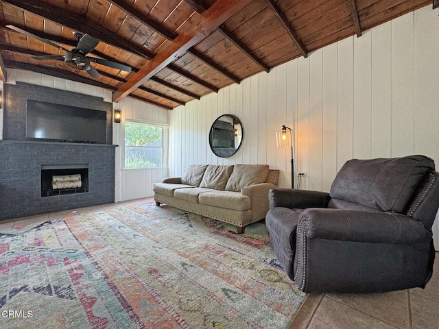 living room featuring ceiling fan, vaulted ceiling with beams, wooden ceiling, and a fireplace