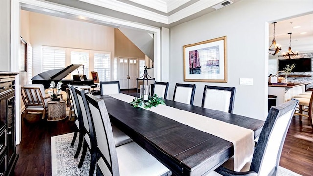 dining room featuring dark hardwood / wood-style flooring and a notable chandelier