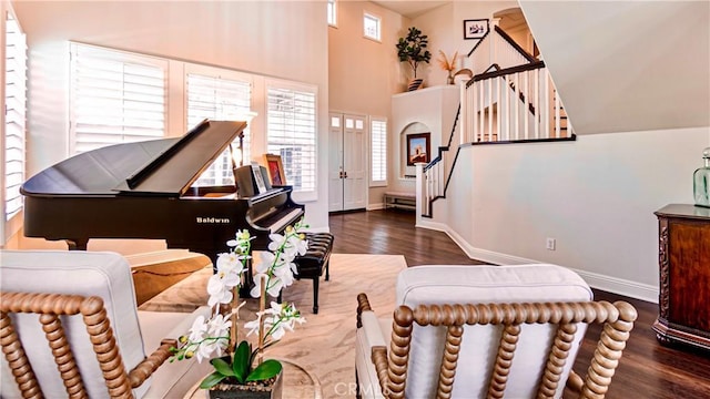 sitting room with dark hardwood / wood-style floors and a high ceiling