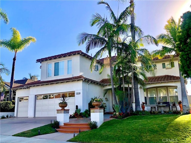 mediterranean / spanish-style home featuring a garage and a lawn