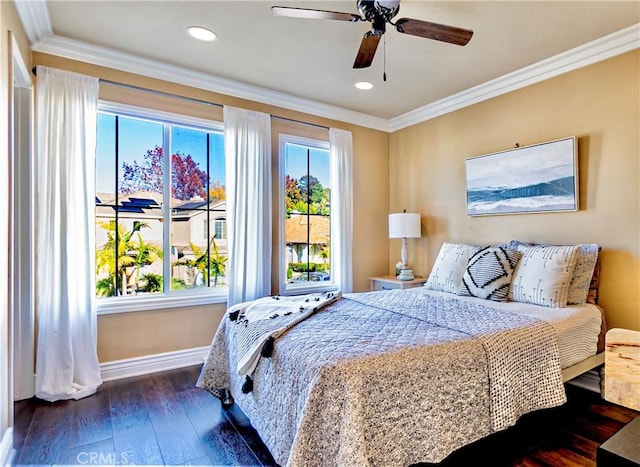 bedroom featuring ceiling fan, ornamental molding, and dark hardwood / wood-style flooring