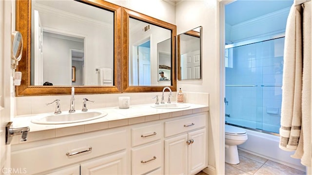 full bathroom with toilet, shower / bath combination with glass door, ornamental molding, vanity, and tile patterned flooring