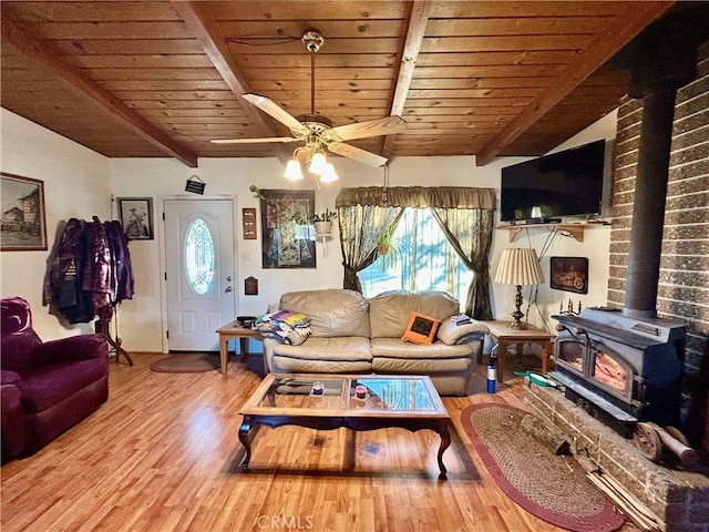 living room featuring vaulted ceiling with beams, hardwood / wood-style floors, wooden ceiling, and ceiling fan