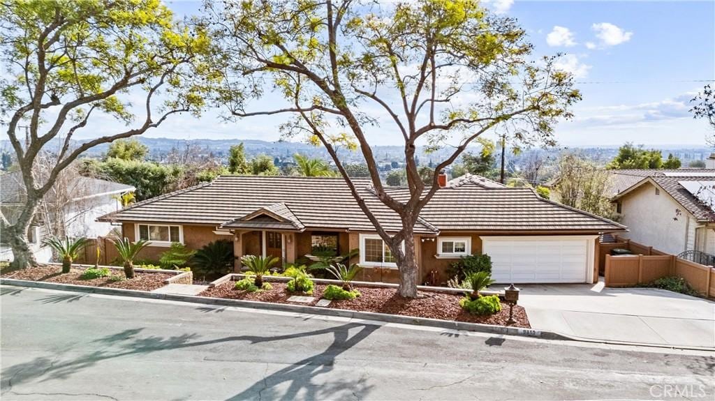 single story home featuring a garage and a mountain view