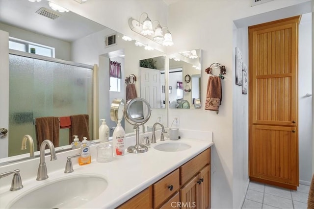 bathroom featuring tile patterned flooring, vanity, and an enclosed shower