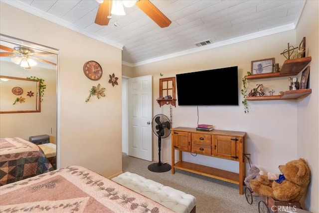 carpeted bedroom featuring crown molding and ceiling fan