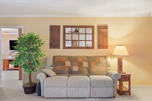 carpeted living room with ceiling fan and ornamental molding