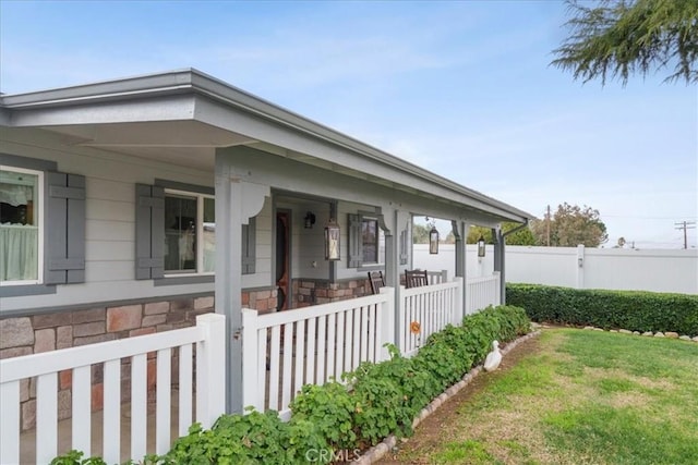 view of side of property featuring a porch and a yard