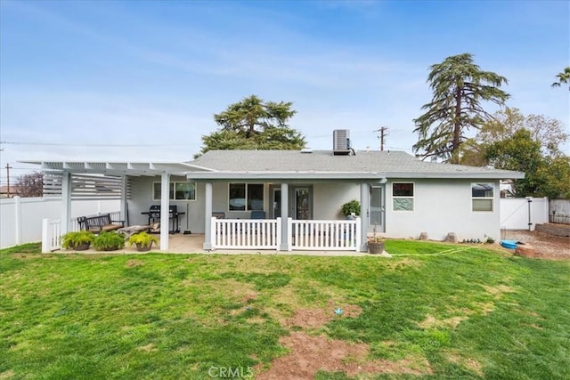 back of house with a pergola, a patio area, and a lawn