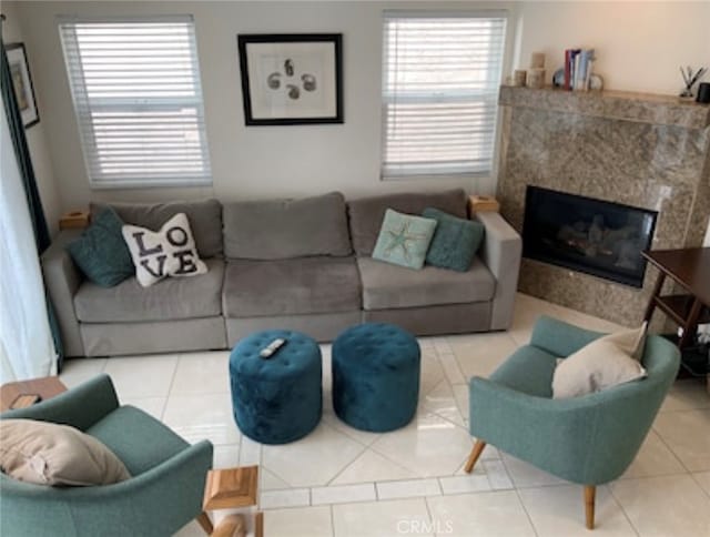 tiled living room featuring a wealth of natural light and a high end fireplace