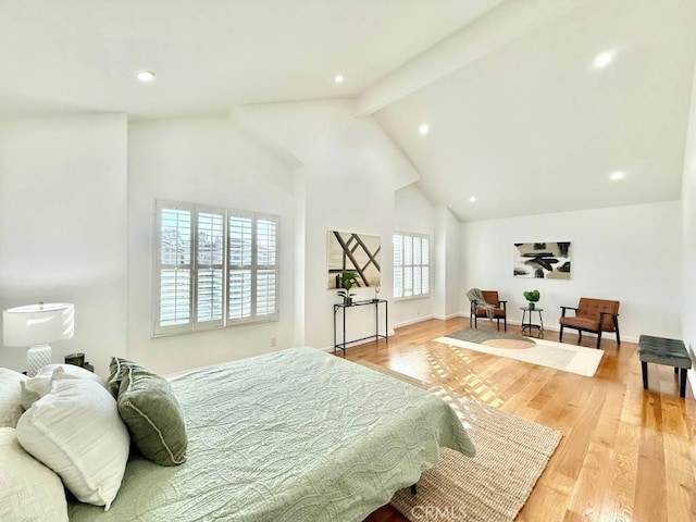 bedroom featuring high vaulted ceiling, beam ceiling, and light hardwood / wood-style floors