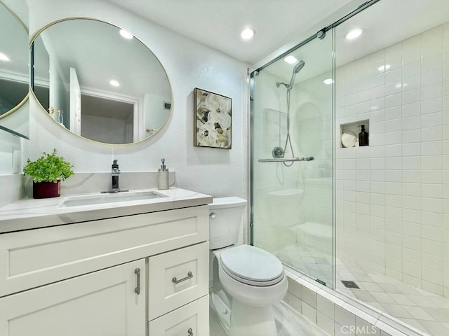 bathroom with vanity, toilet, and walk in shower