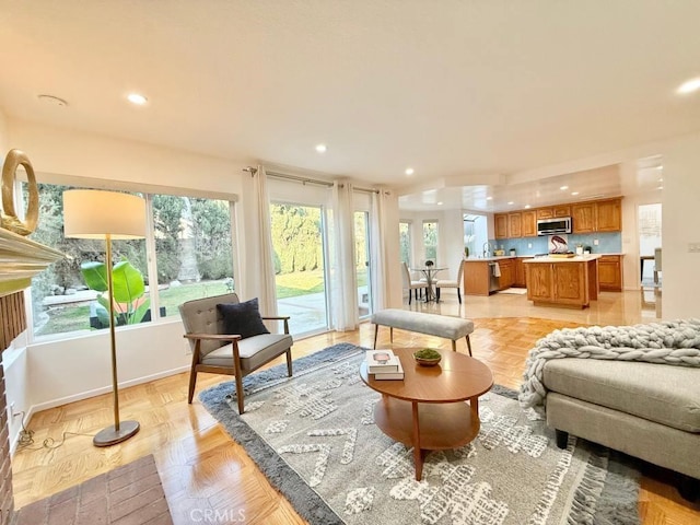 living room featuring plenty of natural light and light parquet floors