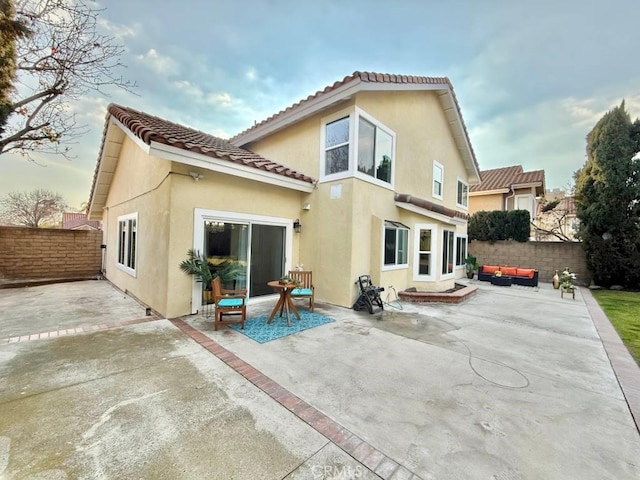 rear view of house featuring outdoor lounge area and a patio