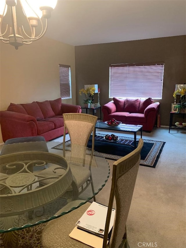 living room with a notable chandelier and carpet floors