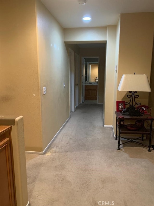 hall featuring light colored carpet