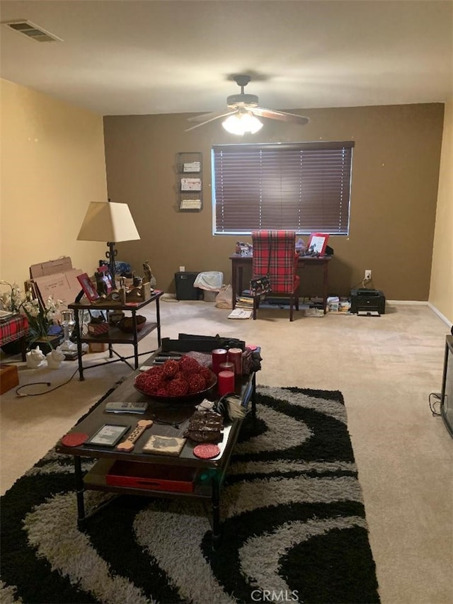 living room featuring carpet and ceiling fan