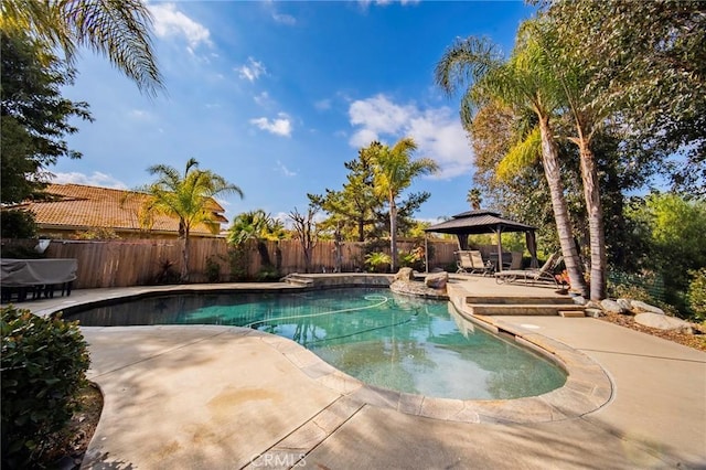 view of swimming pool with a gazebo and a patio area