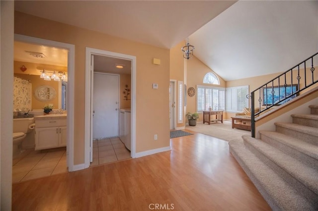 foyer featuring lofted ceiling and light hardwood / wood-style floors