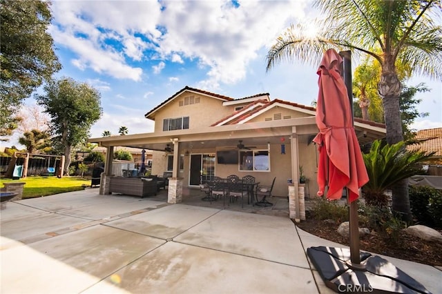 back of property with ceiling fan, outdoor lounge area, a playground, and a patio