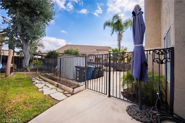 view of gate featuring a lawn