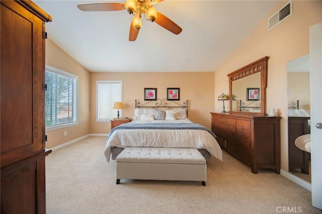 bedroom with ceiling fan, light colored carpet, and lofted ceiling