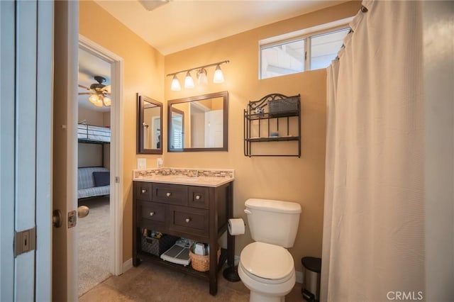 bathroom with tile patterned flooring, vanity, toilet, and ceiling fan