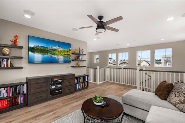 living area with recessed lighting, a ceiling fan, and light wood-style floors