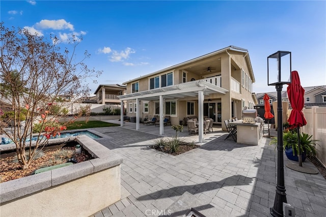 rear view of house featuring a patio area, a fenced backyard, a ceiling fan, and stucco siding