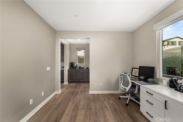 office featuring baseboards and wood finished floors