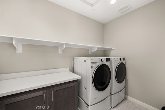 laundry area featuring cabinet space, baseboards, visible vents, and independent washer and dryer