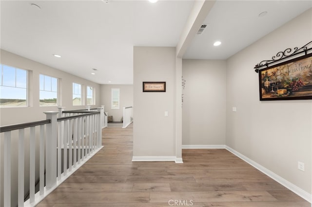 hall featuring recessed lighting, visible vents, an upstairs landing, baseboards, and light wood-type flooring