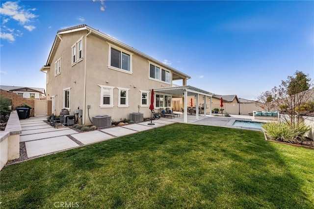 back of property featuring a fenced backyard, a yard, a patio, and stucco siding